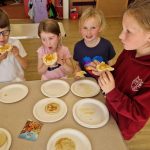 children cooking and eating pancakes